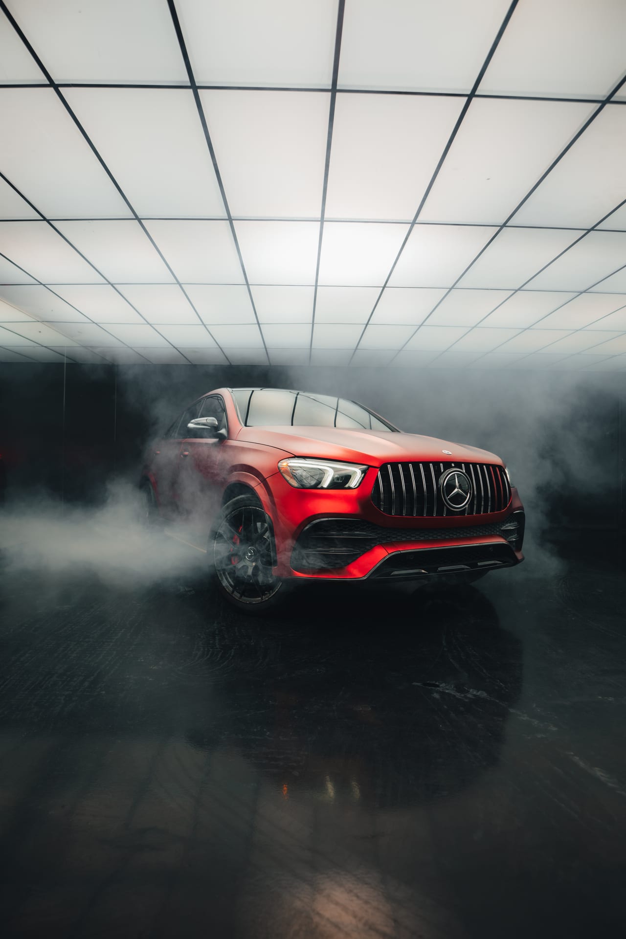 Mercedes-AMG GLE in red surrounded by atmospheric smoke